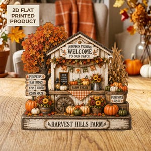 May include: A 2D flat printed decorative sign of a Harvest Hills Farm pumpkin patch stand. The structure features a welcome sign, a large autumn tree, stacked pumpkins, corn stalks, and wooden crates. The base is labeled Harvest Hills Farm.