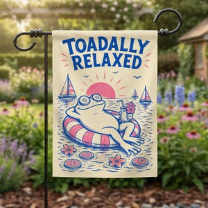 May include: A rectangular garden flag featuring a cream background with the blue text TOADALLY RELAXED. The illustration shows a frog wearing cucumber slices on its eyes, floating in a pink and white striped inner tube, holding a drink.