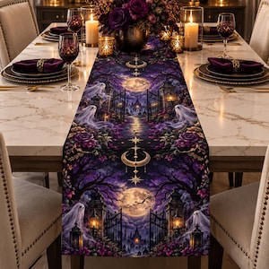 May include: A rectangular table runner featuring a dark purple and black gothic scene with a full moon, iron gates, bare trees, and translucent white ghosts. The design includes floral accents, hanging crescent moon symbols, and stars.