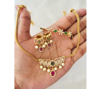 Gold Plated Cubic Zirconia Lotus Necklace Set, Emerald Green Drop Choker, Faux Ruby Pendant, Delicate Floral Crystal Kada Bracelet Set