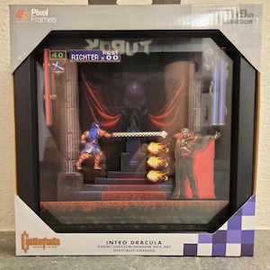 May include: A Pixel Frames shadow box art featuring a Castlevania scene with Richter and Dracula. The 9x9 inch display shows pixelated characters, a throne, and fire effects. The packaging includes the text Castlevania, Intro Dracula, and 9x9in.
