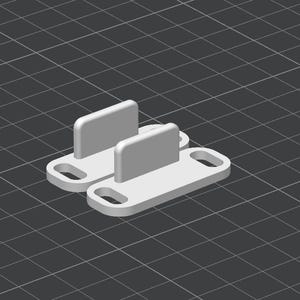 May include: Two light gray, rectangular objects with rounded tops and a rectangular base with a hole on each end. The objects are on a dark gray grid background. The objects appear to be 3D printed.