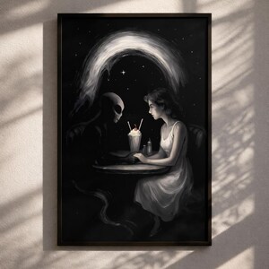 May include: A framed wall art print featuring a black and white illustration of a person and an alien sitting at a small round table. They are holding hands across a milkshake with a red cherry on top, set against a dark starry night sky.