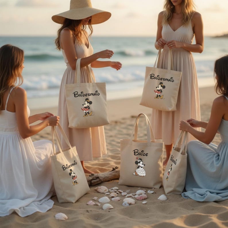 May include: Off-white canvas tote bags featuring Minnie Mouse illustrations and the text Bride or Bridesmaid. The bags have two top handles and are made of fabric. Each bag displays a cartoon character wearing a dress and a bow.