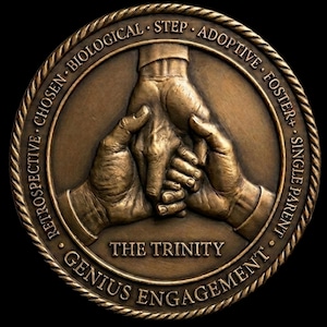 May include: A circular bronze medallion featuring a relief of three hands interlocked. The words "THE TRINITY" are in the centre, encircled by the text: "RETROSPECTIVE • CHOSEN • BIOLOGICAL • STEP • ADOPTIVE • FOSTER • SINGLE PARENT • GENIUS ENGAGEMENT".