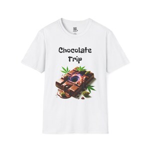 May include: White t-shirt with the text "Chocolate Trip" in black. The graphic features a chocolate bar with a swirling center, cannabis leaves, and buds. The design is colorful and eye-catching.