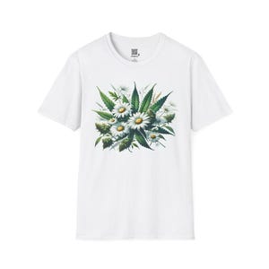 May include: White t-shirt with a floral design combining daisies and cannabis leaves. The graphic has a watercolour effect, with green leaves and white daisy petals around yellow centres. The shirt is a classic crew neck style.