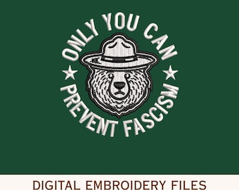 May include: A digital embroidery design featuring a bear wearing a ranger hat, encircled by the text "ONLY YOU CAN PREVENT FASCISM" in white on a dark green background. The design includes the text "DIGITAL EMBROIDERY FILES" and file type abbreviations.