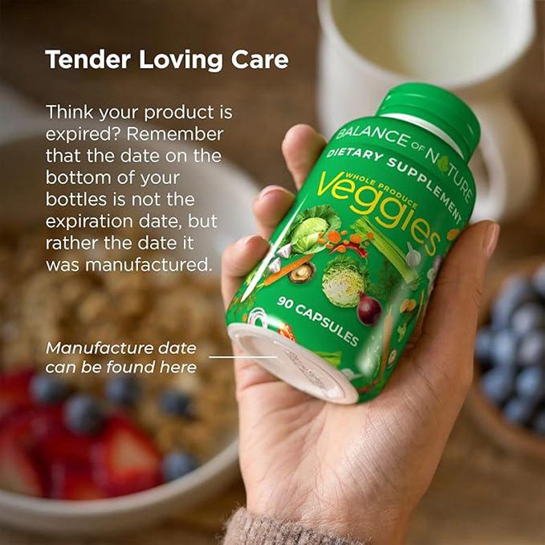 May include: A green bottle of "Balance of Nature Veggies" dietary supplement, held in a hand. The bottle features images of vegetables and the text "90 Capsules." The text "Tender Loving Care" and product information are also visible.