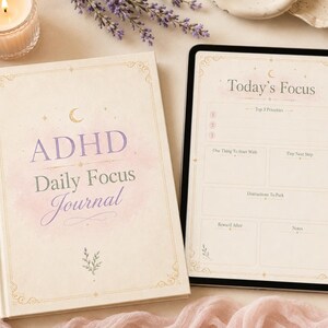May include: A cream-colored hardcover journal with the text ADHD Daily Focus Journal in purple and gray, alongside a tablet displaying a Today's Focus planner template with sections for priorities, tasks, and notes, accompanied by a gold pen.
