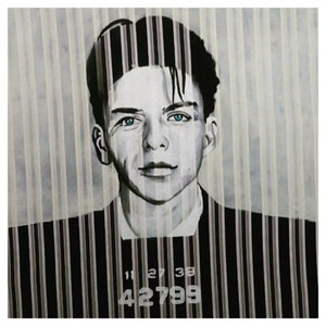 May include: Black and white portrait of a man with blue eyes, set against a striped background. The image includes the numbers "11 27 38" and "42799" at the bottom. The man is wearing a dark suit.