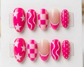May include: A set of ten press-on nails featuring a vibrant pink and light pink color palette. The designs include white stars, wavy lines, a checkered pattern, a French tip style with a nude base, and white polka dots on a solid pink background.