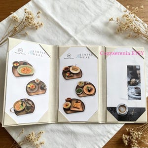 May include: A tri-fold menu display featuring the text Simple Meal and Beauty Studio. The panels showcase various food photography layouts on wooden trays, including pasta, toast, and coffee, with a final panel displaying a cup of latte art.