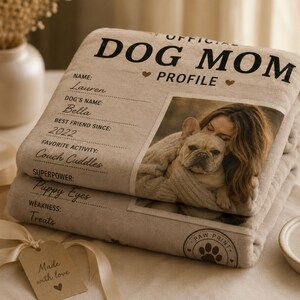 Folded personalized Dog Mom blanket presented as a premium gift with soft neutral styling.