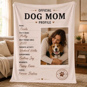 May include: A cream-colored fleece blanket featuring the text OFFICIAL DOG MOM PROFILE. It includes fields for name, dog's name, best friend since, favorite activity, superpower, weakness, and status, alongside a photo of a person and a beagle.