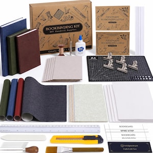 May include: A comprehensive bookbinding kit featuring a cardboard box labeled BOOKBINDING KIT, three bound journals, two instructional guides, a black A4 cutting mat, metal clips, glue, paper sheets, fabric rolls, a ruler, a bone folder, and tools.