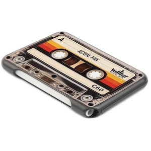 May include: A clear and grey phone case featuring a retro cassette tape design. The tape label reads "Royal Mix" with a colourful stripe design and the text "C60". The case has a dark grey border.
