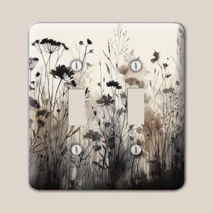 May include: A rectangular double light switch cover plate featuring a watercolor-style print of black and sepia-toned wildflowers and tall grasses against a cream background. The plate includes two vertical rectangular cutouts and four screws.