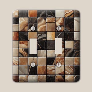 May include: A double light switch wall plate featuring a grid pattern of square tiles with a faux marble finish in shades of black, dark brown, tan, and cream. The rectangular plate includes two vertical toggle switch cutouts and four screws.