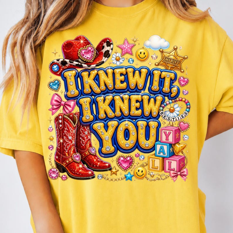 May include: A yellow t-shirt featuring a graphic print with the text I KNEW IT, I KNEW YOU. The design includes a red cowboy hat, red cowboy boots, a sheriff badge, smiley faces, pink bows, colorful hearts, stars, and stacked alphabet blocks.