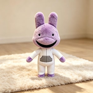 May include: A plush toy featuring a purple rabbit-like head with long ears, small black eyes, and a wide black mouth. The body is a white jumpsuit with a gray front pocket and long sleeves, with purple fabric visible at the hands and feet.