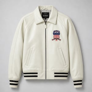 May include: An off-white leather jacket featuring a full-length front zipper, a classic collar, and ribbed cuffs and hem with black stripes. The left chest displays an embroidered patch with the text AVIREX above a red, white, and blue shield.