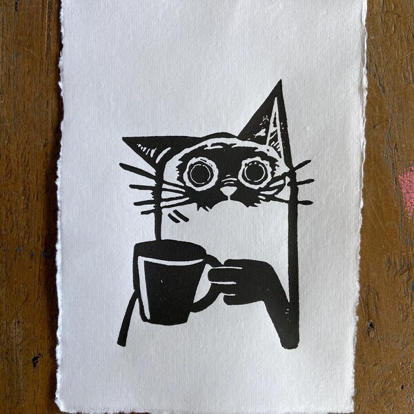 original black disheveled cat drinking coffee linocut art