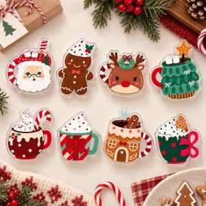 May include: A set of eight acrylic Christmas-themed pins featuring various designs including a Santa mug, a gingerbread person, a reindeer, a tree mug, a hot cocoa mug with a candy cane, a striped mug, a gingerbread house mug, and a polka dot mug.