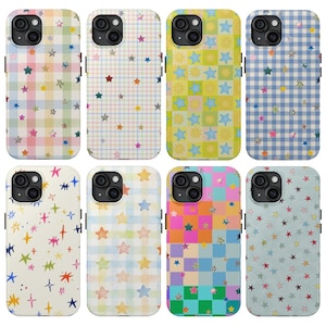 May include: Eight smartphone cases featuring various patterns including pastel plaid, checkered grids, and scattered star or sun motifs. The designs incorporate diverse color palettes such as blue, pink, yellow, green, and orange, with some cases displaying holographic or metallic star accents.