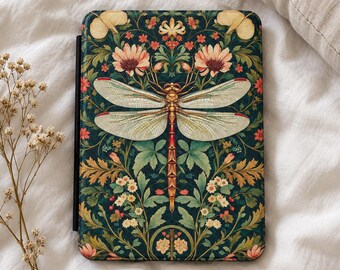 May include: A rectangular e-reader case featuring a dark green background with a symmetrical pattern of light green leaves, small white and pink flowers, and a large central dragonfly with translucent wings and a reddish-brown body.