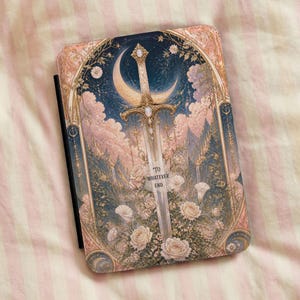 May include: A rectangular e-reader case featuring a central sword illustration pointing upward, surrounded by a crescent moon, clouds, and white roses. The design is framed by an ornate archway with the text "TO WHATEVER END" printed on the sword blade.