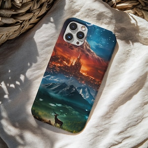 May include: A smartphone case featuring a vibrant, multi-layered landscape illustration. The design depicts a dark, silhouetted deer in a forest foreground, transitioning into snow-capped mountains, and a glowing, futuristic city under a starry sky.