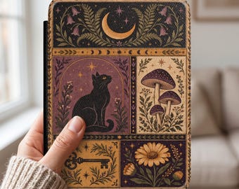 May include: A rectangular e-reader case featuring a multi-panel illustration. The top panel shows a crescent moon and foliage. Below, a black cat sits in a purple frame, next to purple mushrooms. The bottom panels display a skeleton key and a yellow flower.