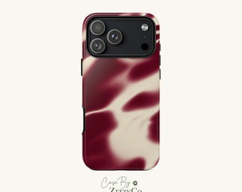 May include: A smartphone case featuring a blurred, abstract pattern of deep burgundy and cream colors. The case has a black camera module cutout with three circular lens openings and a flash, designed for a modern mobile device.