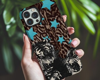 May include: A smartphone case featuring a brown and black leopard print background overlaid with bright cyan stars and a graphic illustration of three snarling tiger heads in black, white, and gray tones at the bottom section.