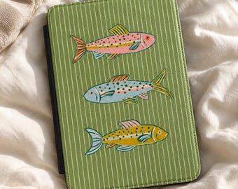 May include: A rectangular e-reader case featuring a sage green background with thin white vertical pinstripes. The cover displays three embroidered fish illustrations in pink, light blue, and yellow, each with detailed scales.