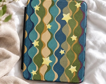 May include: A rectangular e-reader case featuring a repeating pattern of vertical wavy lines in shades of dark blue, teal, olive green, and tan. The surface is decorated with scattered pale yellow five-pointed stars of varying sizes.