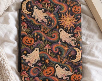 May include: A rectangular e-reader case featuring a dark background with a colorful pattern of white ghosts, orange jack-o'-lanterns, yellow suns, crescent moons, red mushrooms, butterflies, bats, and swirling rainbow-colored cosmic clouds.