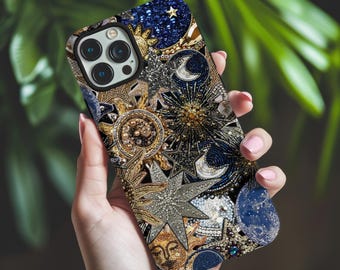 May include: A smartphone case featuring a dense, intricate celestial pattern of gold, silver, and deep blue beads. The design includes sun faces, crescent moons, and various star shapes arranged in a complex, textured mosaic across the surface.
