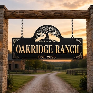 May include: A black metal sign hanging from chains between two stone pillars. The sign features a cutout of an oak tree at the top, the text OAKRIDGE RANCH in gold lettering, and the text EST. 2025 below it, with decorative scrollwork on the sides.