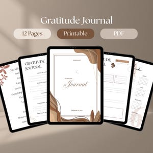 Peut inclure: Un journal de gratitude numérique affiché sur plusieurs écrans de tablette, comprenant 12 pages au format PDF imprimable. Les pages incluent des sections pour les affirmations quotidiennes, des invites de gratitude et un calendrier 2026-2027.