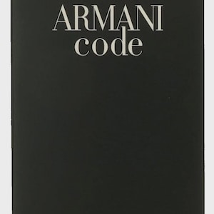 May include: Black rectangular box of Armani Code Eau de Parfum. The brand name "ARMANI code" is in white, above the text "EAU DE PARFUM" and "GIORGIO ARMANI". The box also says "VAPORISATEUR RECHARGEABLE REFILLABLE SPRAY".