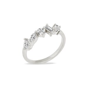 May include: A silver-toned ring featuring a cluster of five clear, faceted stones set along the top band. The arrangement includes two marquise-cut stones, one round brilliant-cut stone, one rectangular baguette-cut stone, and one small round stone.