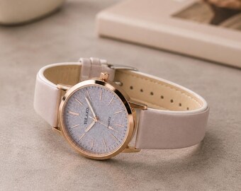 Reloj de lujo de diseño para mujer: correa de piel y esfera redonda minimalista.