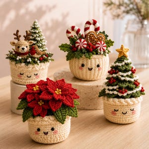 May include: Four crocheted amigurumi planters with smiling faces. One features a reindeer and tree, one has candy canes and a gingerbread heart, one displays a red poinsettia, and one shows a decorated Christmas tree with a yellow star.