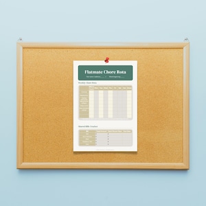 May include: A rectangular cork bulletin board with a wooden frame, featuring a pinned white paper sheet titled Flatmate Chore Rota. The document includes a weekly chore grid and a shared bills tracker with columns for amounts and due dates.