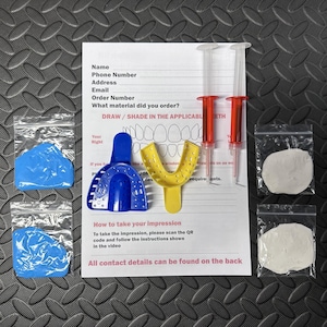 May include: Dental impression kit featuring a blue and yellow tray, two syringes, and bags of white and blue material. A sheet of paper with instructions and a tooth diagram is also included.