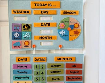 May include: A light blue felt educational calendar with orange text labels for weather, day, date, month, and season. Includes weather icons and a seasonal wheel. The lower section displays days, dates, and months with colorful labels.