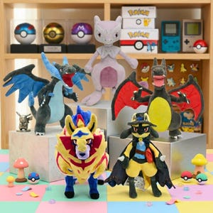 May include: A collection of Pokémon plush toys, including Charizard, Mewtwo, and Zacian, displayed on a shelf. The plushies are various colors and sizes, with detailed features. Other items include Poké Balls and game consoles.