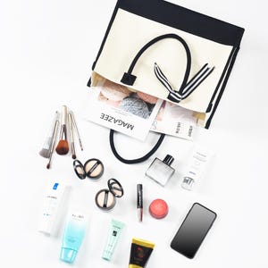 the contents of a purse are laid out on a white surface